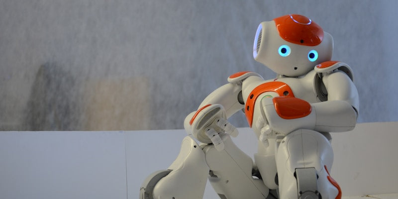 white and orange robot near wall